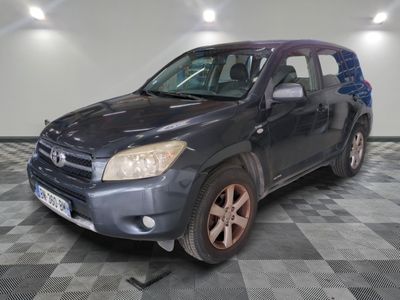 a picture of a blue toyota rav parked in a garage