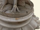 a statue of a bird sitting on top of a pedestal
