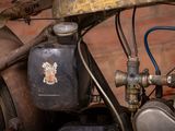 a close up of an old motorcycle with a badge on it