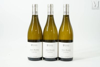 three bottles of white wine sitting next to each other on a white surface