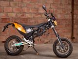 a motorcycle that is parked in front of a brick wall