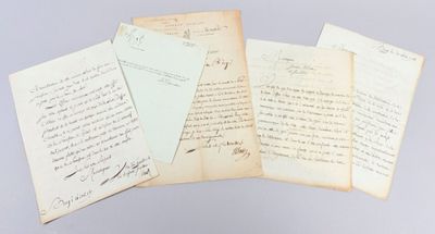 several old papers are stacked on top of each other on a table