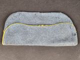 a close up of a gray and yellow bag on a brown surface
