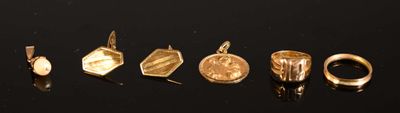 five different types of gold rings on a black surface