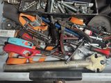a drawer full of assorted tools in a garage
