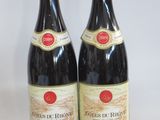 two bottles of wine sitting next to each other on a table