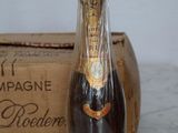 a bottle of champagne sitting on a table next to a box
