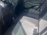 the back seat of a car with a seat belt in the back of it