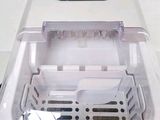 a close up of a small white machine on a table
