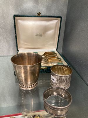 silver cups and silver spoons on a glass table