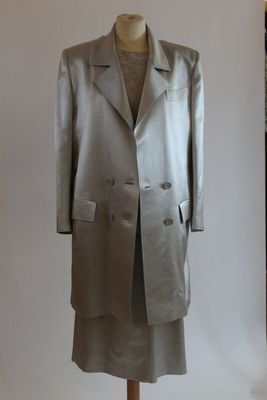 an image of a dress and coat on a mannequin stand