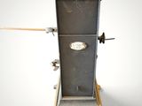 a metal stove with a wooden top on a stand