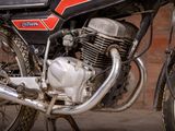 a motorcycle parked in front of a brick wall