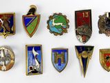 a lot of badges that are on a white surface