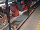many shelves with pots and bowls on them in a warehouse