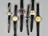 several different types of watches are lined up on a table