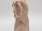 a small sculpture of a bear with a hat on