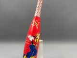 the baseball bat has a cartoon character on it and is on a clear base