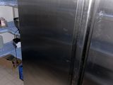 a stainless steel refrigerator in a kitchen with shelves