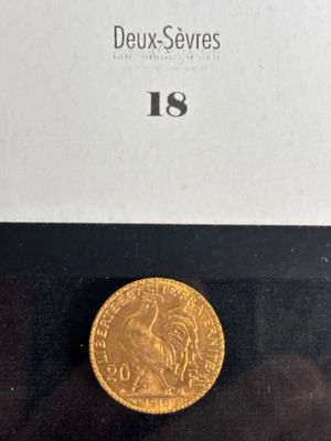 a close up of a gold coin on a black surface