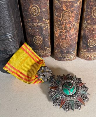 a medal and a book on a table next to a row of books