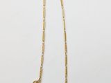 a gold chain necklace with coins on a white background