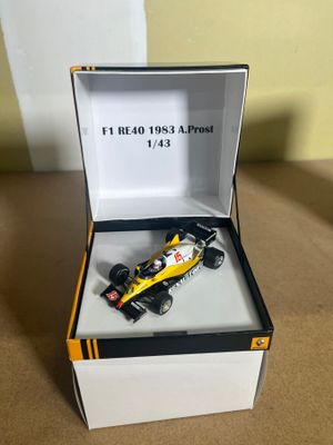 yellow and black model of a racing car in a box
