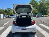 a white car with its trunk open on the street