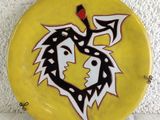 a yellow plate with a picture of a dragon on it