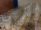 many glasses on the shelf in the room