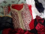 a picture of a red and white dress and a blue purse