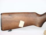 a rifle with a wooden stock and a wooden barrel on a white background