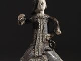 statue d'une femme en robe tenant un oiseau dans la main