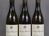 three bottles of wine sitting on a table next to each other