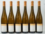 six bottles of wine are lined up in a row