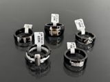 four different rings with tags on them sitting on a table