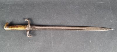 a close up of a knife with a wooden handle on a table