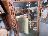 a large mirror sitting on the floor next to a chair