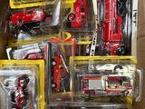a box full of different types of toy fire trucks