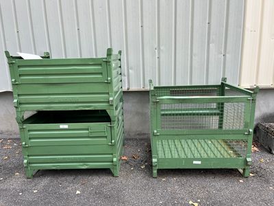 two green crates sitting next to each other on the street