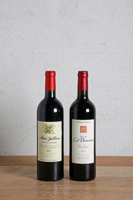 two bottles of wine sitting on a wooden table next to a bottle of wine
