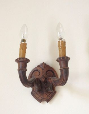 two wall sconces that are attached to the wall