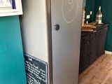 a refrigerator with a chalkboard on the door in the kitchen