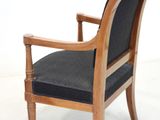 a wooden chair with a black cushion on it