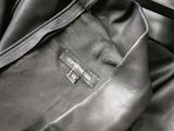 the back of a black leather jacket with a zipper down the side