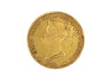 a close up of a gold coin on a white surface