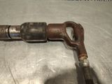 a close up of a metal pipe with a rusted handle