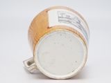 a close up of a coffee cup on a white surface