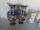 three vases sitting next to each other on a table