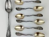 five spoons and two spoons on a white surface